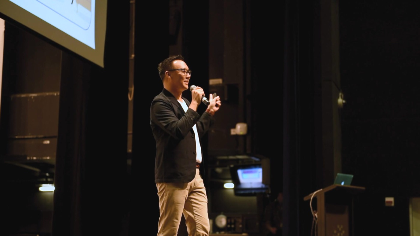 Mac Ling speaking on stage at Singapore International School Hong Kong